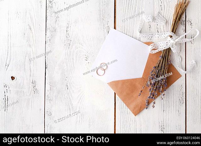 Wedding invitation card with envelope on wooden table