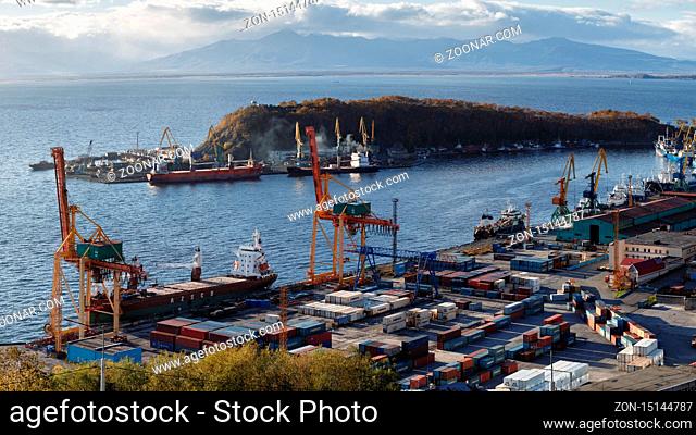 PETROPAVLOVSK KAMCHATSKY CITY, KAMCHATKA, RUSSIA - OCT 3, 2017: Panoramic view of ships at pier, port cranes on commercial seaport Petropavlovsk-Kamchatsky on...