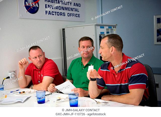 Astronauts Charlie Hobaugh (right), STS-129 commander; Barry Wilmore (left), pilot; and Mike Foreman, mission specialist
