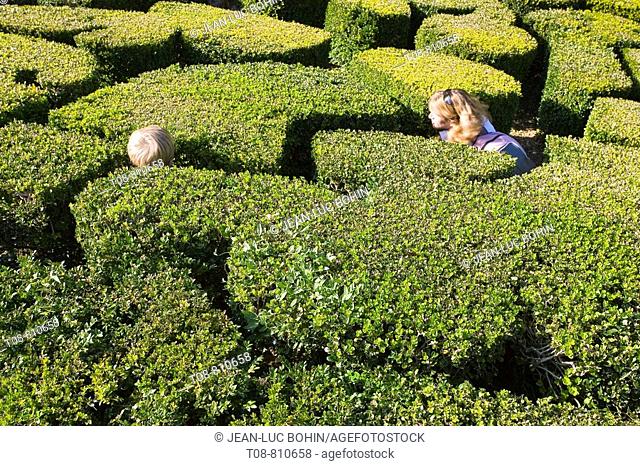 France, Ile de France, park of Breteuil castle: woman and child in the hedge