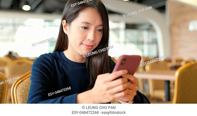Woman use of cellphone in restaurant