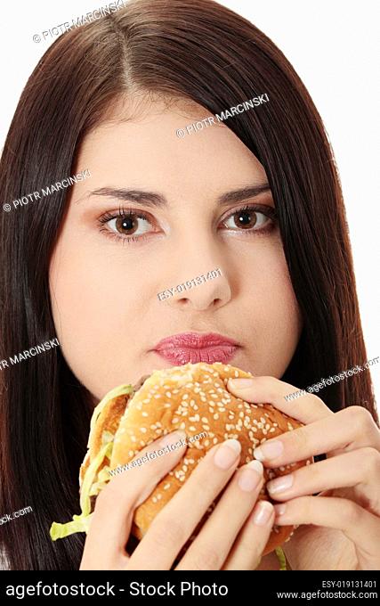 Beautiful caucasian woman eating hamburger