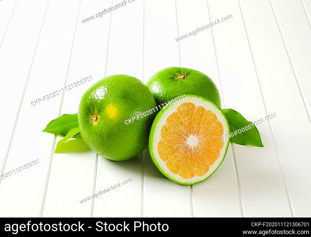 Two and a half sweetie fruits (green grapefruits, pomelits) and leaves