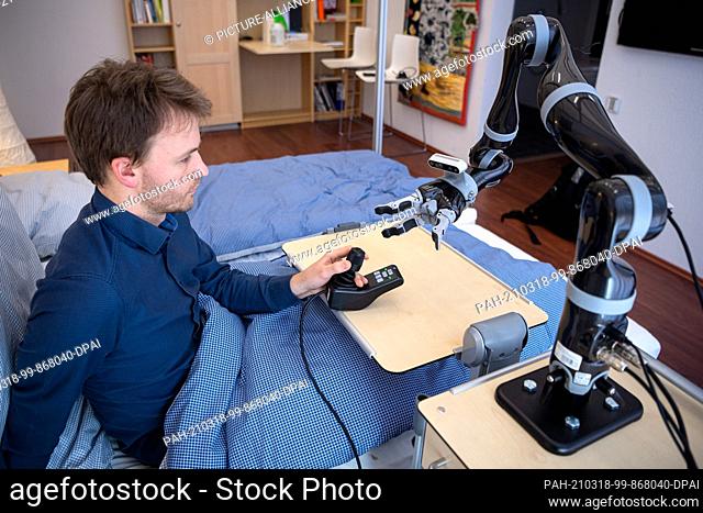 26 February 2021, Bremen: Felix Goldau, research associate, is working at the German Research Center for Artificial Intelligence on a robotic arm that will help...