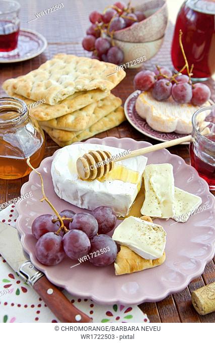 Bread, cheese and red grapes