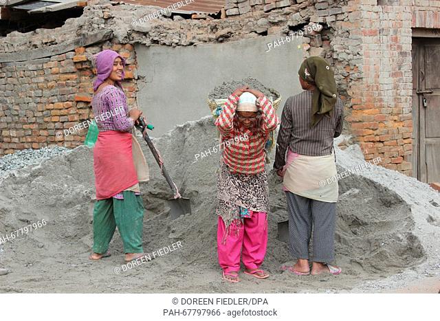 Women work in the reconstruction of homes in Bhaktapur, Nepal, 31 March 2016. Many peaople in rural regions have no funds for the reconstruction of their homes...