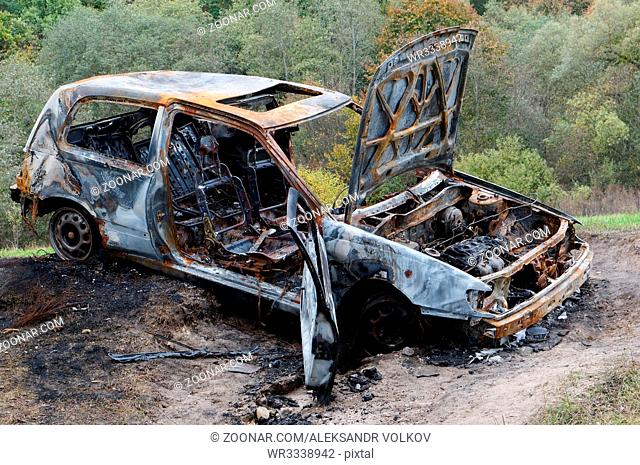The stolen burned down car in the autumn wood
