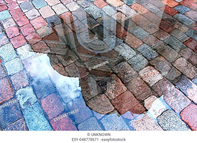reflection of the cathedral in a puddle after rain in the medieval town of Tallinn, Estonia