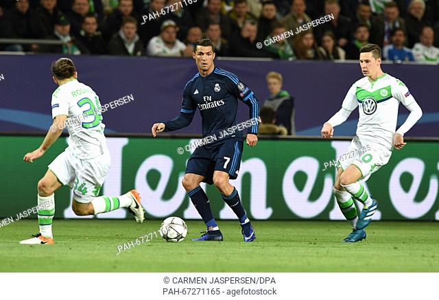 Madrid's Cristiano Ronaldo (C) and Wolfsburg's Ricardo Rodriguez (L) and Julian Draxler vie for the ball during the Champions League quarter final soccer match...