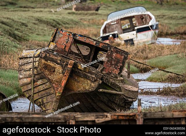 The wrecks of two boats in the grass, seen in Askam-in-Furness, Cumbria, England, UK
