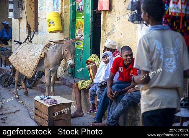 Local people small shops and houses and narrow strees of the city town of Lamu in Kenya