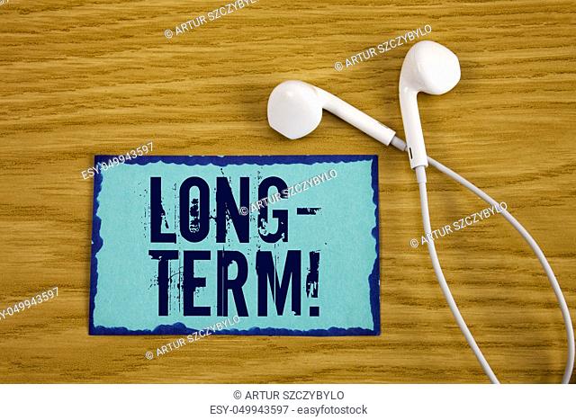 Writing note showing Long-Term Motivational Call. Business photo showcasing Occurring over large period of time Future plans written Sticky Note Paper wooden...