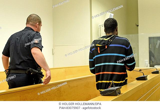 Daniel F., who is accused of attempted murder, enters a courtroom at the regional court in Hanover, Germany, 25 August 2016