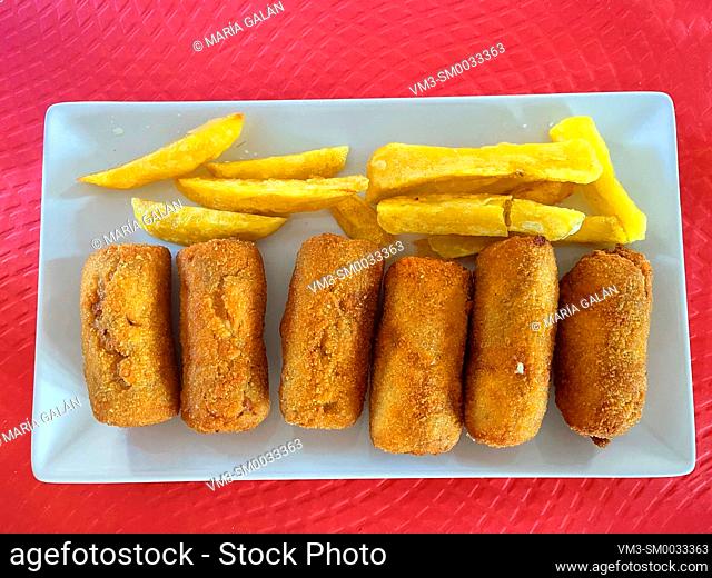 Croquettes with fried potatoes serving. Spain