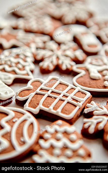Composition of delicious gingerbread cookies shaped in various Christmas symbols. Placed on white rusty table. Top view