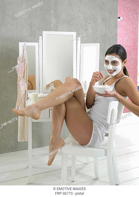 Woman in white underwear with curd mask