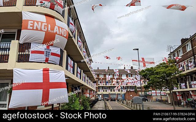 17 June 2021, United Kingdom, London: In Bermondsey, east London, the residents of the Kirby Estate hang out flags. Since the start of the European Football...