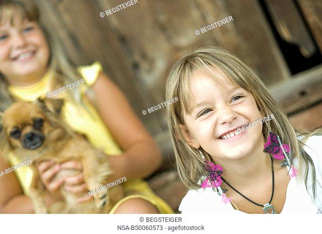 two girls with pekinese in portrait