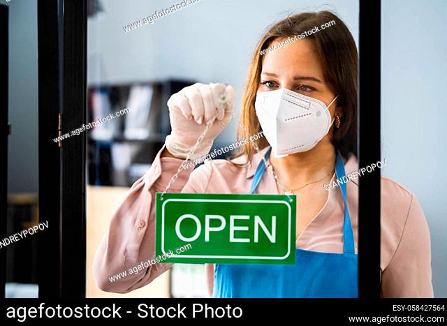 Restaurant Or Cafe Owner With Business Open Sign