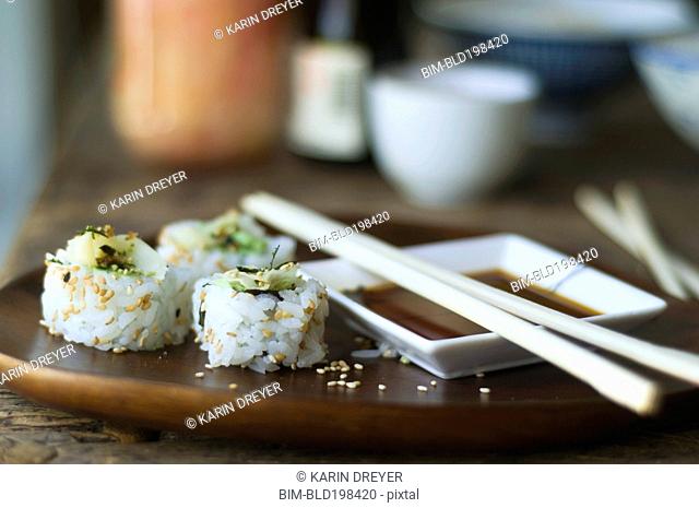 Sushi, sauce and chopsticks on tray