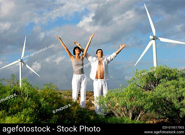 Man and woman turning a blind eye by lifting the arms close to side wind