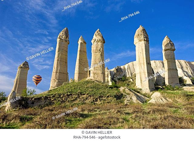 Hot air balloon over the phallic pillars known as fairy chimneys in the valley known as Love Valley near Goreme in Cappadocia, Anatolia, Turkey, Asia Minor
