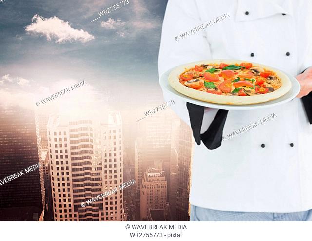 Chef with pizza against blurry skyline