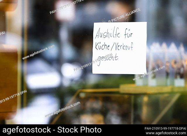 08 September 2021, Schleswig-Holstein, Kiel: A note with the inscription ""Temporary help wanted for kitchen/sales"" hangs on the window of a Kiel pastry shop