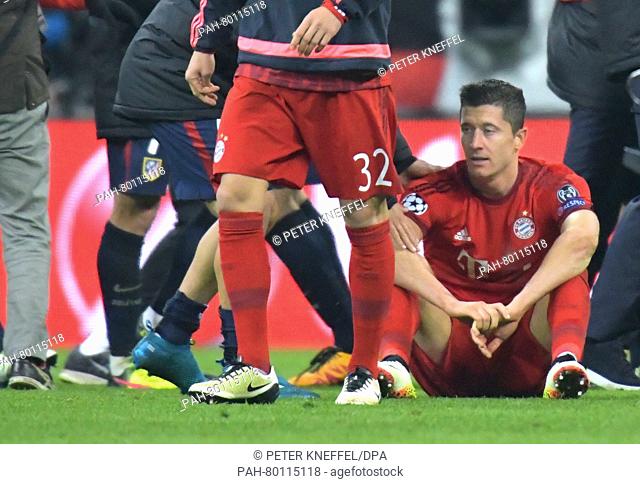 Munich's Robert Lewandowski sits on the pitch after the Champions League semi-final second leg soccer match between Bayern Munich and Atletico Madrid at the...