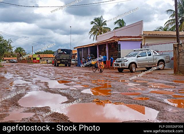 Grocery store along muddy dirt road in the village of Lethem during the rainy season, Upper Takutu-Upper Essequibo region, Guyana, South America