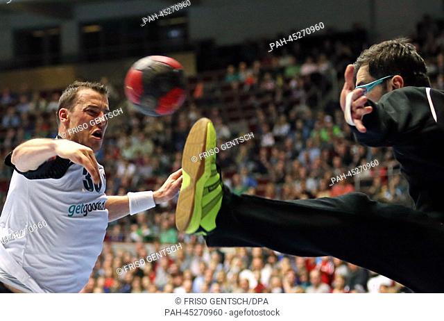 Germany's Dominik Klein (L) in action against Austria's Nikola Marinovic (R) during the Four Nations Tournament handball match between Germany and Austria at...