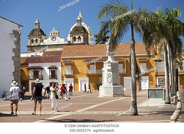 View to the tourists in Plaza De La Aduana Square at the historic center with the colorful colonial buildings at the background, Cartagena, Cartagena de Indias
