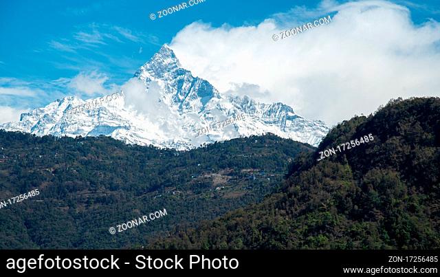 Annapurna massif mountains in the Himalayas covered in clouds, snow and ice in north central Nepal Asia