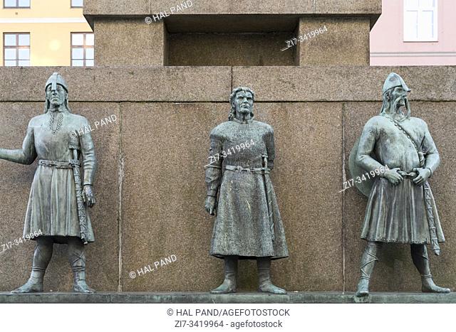 bronze statues on east side of Seaman Monument in town historical center, shot under bright summer light at Bergen, Norway