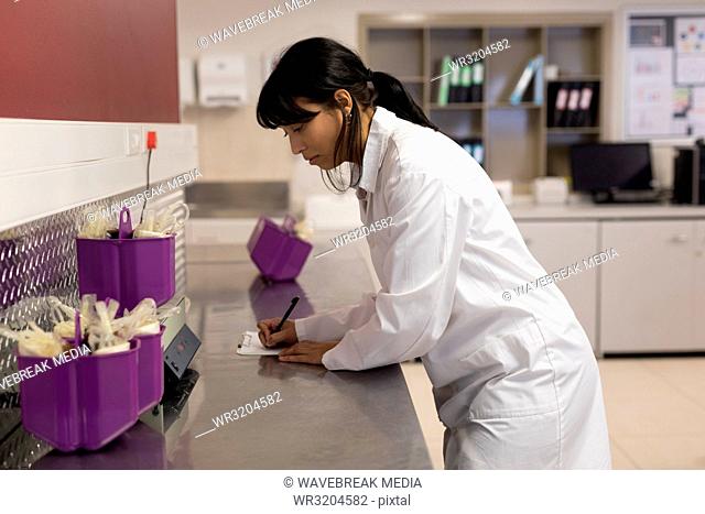 Laboratory technician noting weight of blood bags