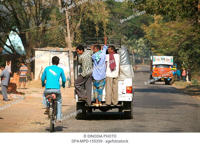 Passengers standing on back of jeep used local transport system in Jharkhand ; India