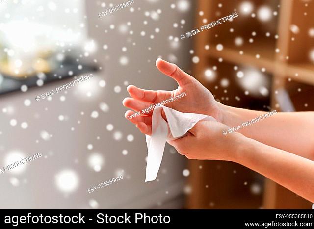 woman cleaning hands with antiseptic wet wipe