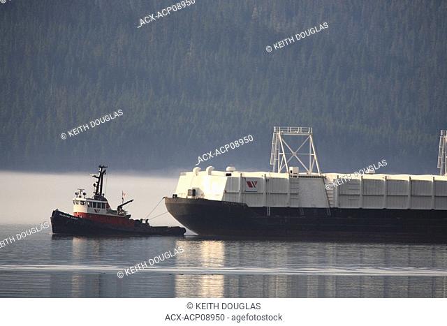 Tugboat and bulk cargo barge heading for Alcan aluminum smelter, Kitimat, British Columbia, Canada