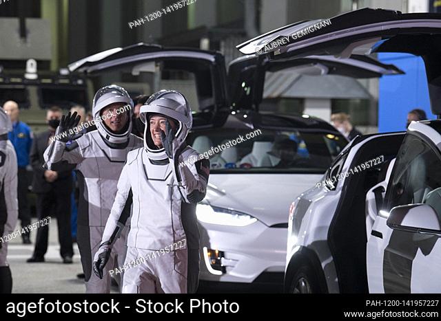 NASA astronauts Shane Kimbrough, left, and Megan McArthur, right wave farewell, as they prepare to depart the Neil A. Armstrong Operations and Checkout Building...