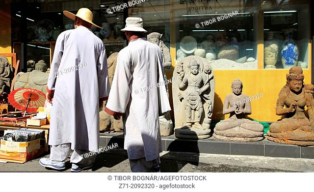 South Korea, Seoul, Insa-dong, monks shopping for Buddhas