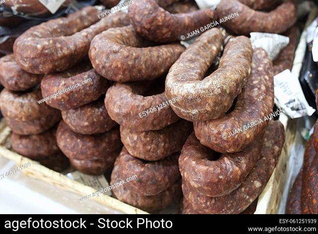 Iberian cured spicy sausage or salchichon. Displayed at street market stall