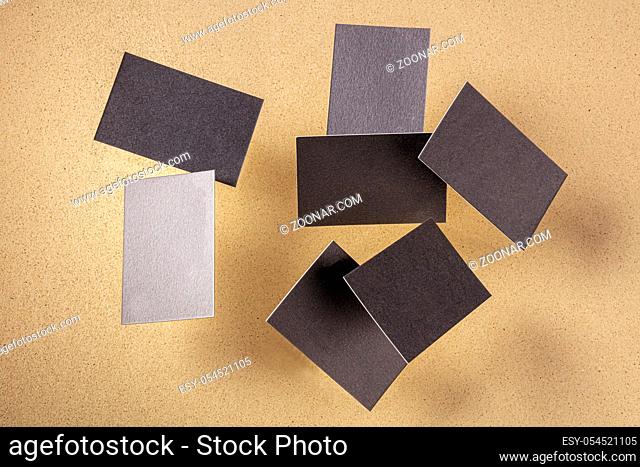 Thick business cards, flying on a brown background, a mockup for design presentation
