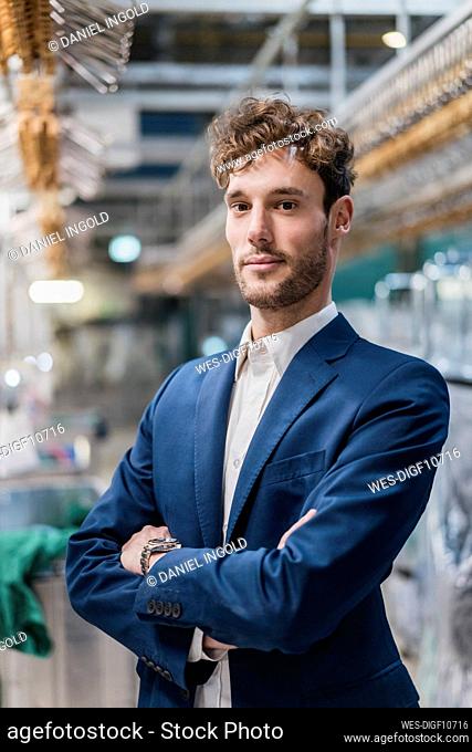 Portrait of a confident young businessman in a factory