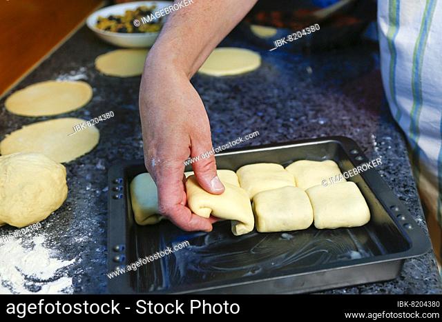 Swabian cuisine, preparing tubular noodles Mediterranean style, hearty, salty, putting yeast yeast dough on baking tray, out of the oven, bake, pastry