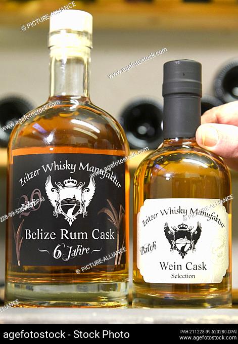 20 December 2021, Saxony-Anhalt, Zeitz: In the Zeitzer Whisky Manufaktur of Daniel Rost are two bottles with six years in a rum barrel of Belize (Central...