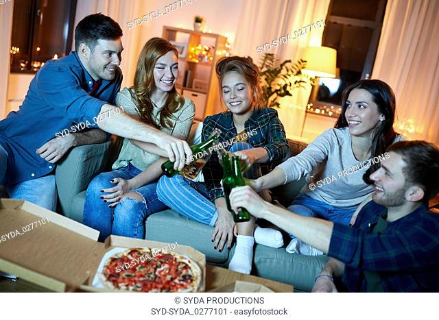happy friends with drinks and pizza party at home