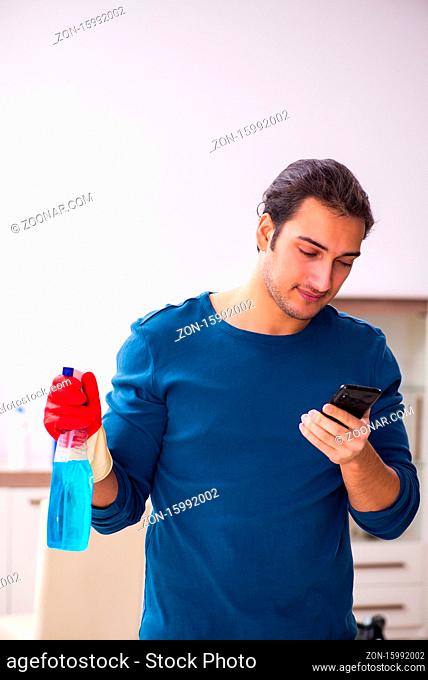 Young man husband doing housework at the home