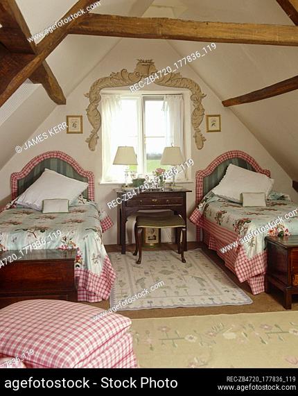 Country style bedroom with slanted ceiling and twin beds