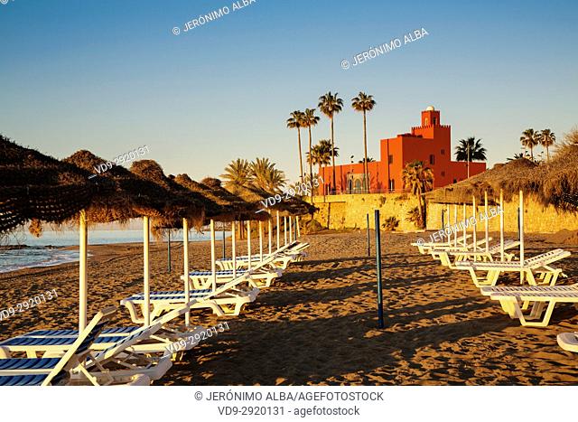Beach hammocks at sunrise. Bil-Bil castle built in neo-Arab style in 1934, Benalmadena. Malaga province Costa del Sol. Andalusia Southern Spain, Europe