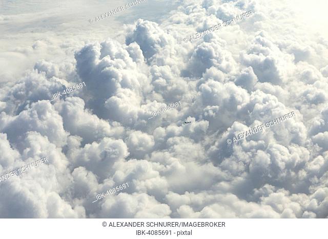 Cloud formations with a small passenger aircraft